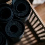 Close-up of rolled yoga mats in a basket at a fitness studio, ideal for yoga or pilates.